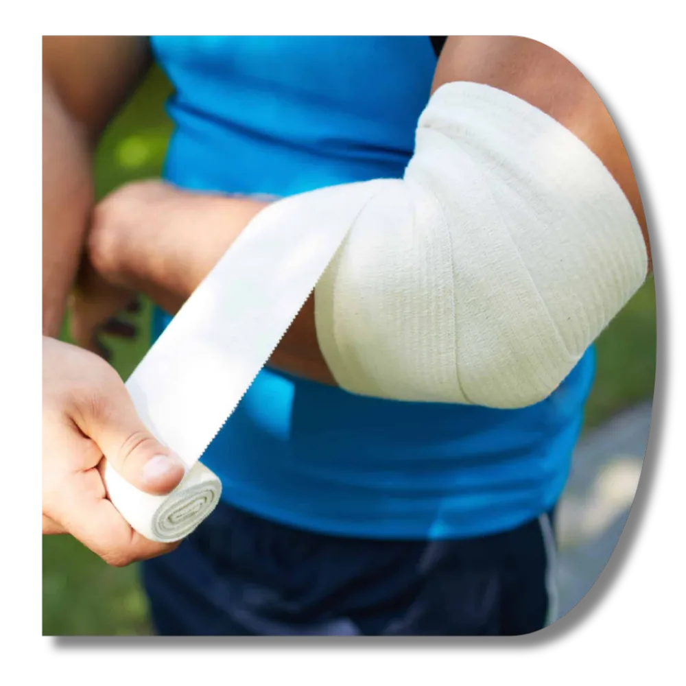 Close-up of a person wrapping a white compression bandage around an injured elbow.