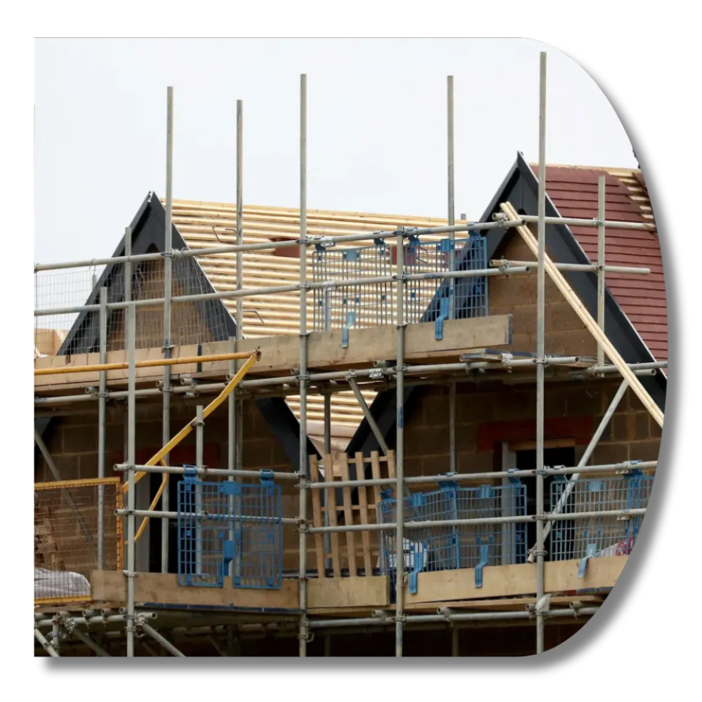Residential house roof under construction with scaffolding and exposed timber framing.