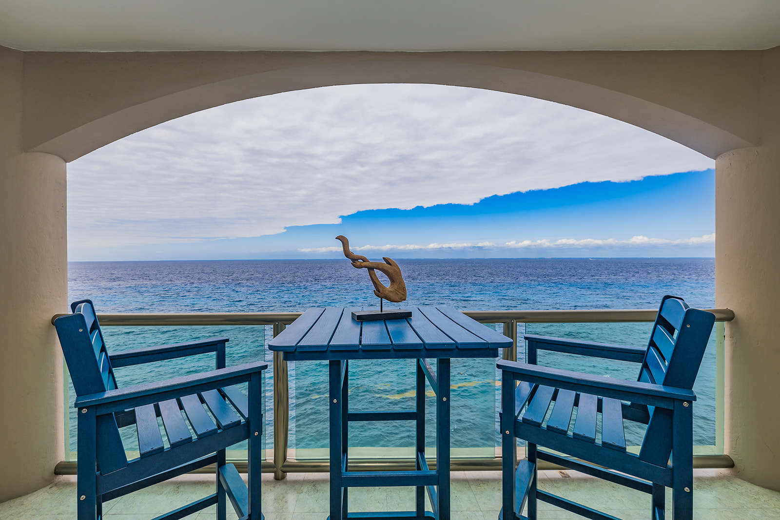 people sitting on gazebo near body of water during sunset