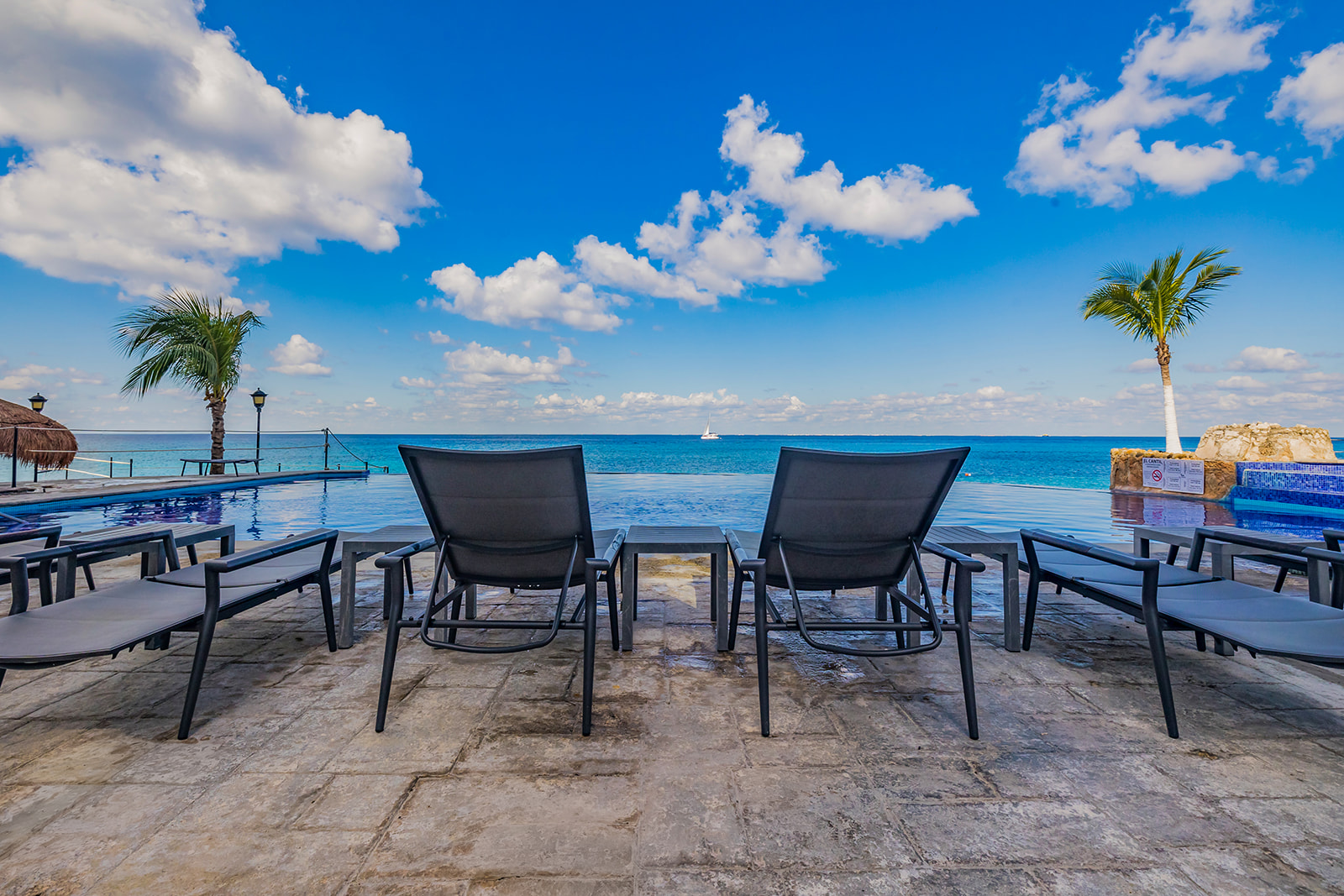 a chair sitting on the edge of a swimming pool