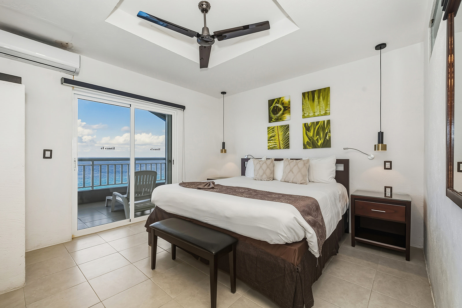 a beach with waves and the sun setting