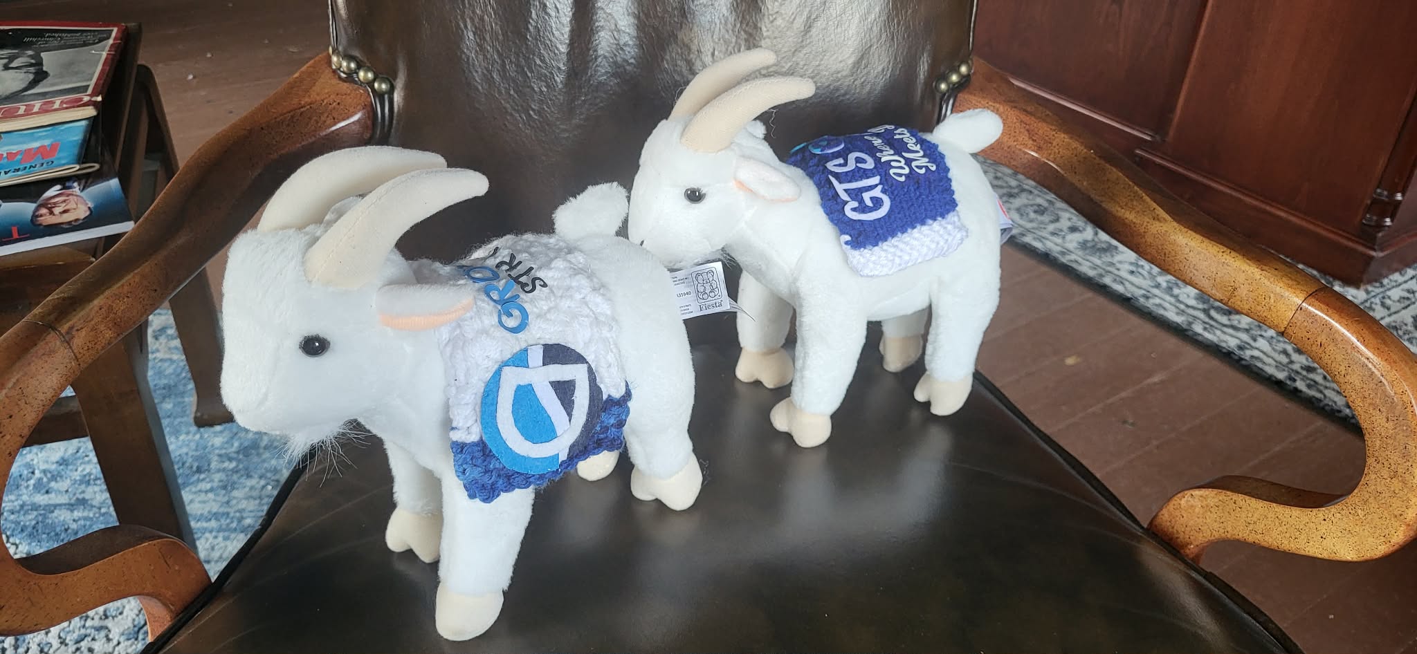two stuffed toy goats with Growth Team Strategies branding on them.