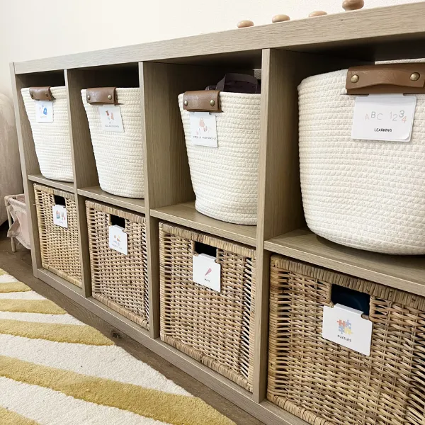 Labeled storage baskets in a cubby system organizing household items for a clean and functional home