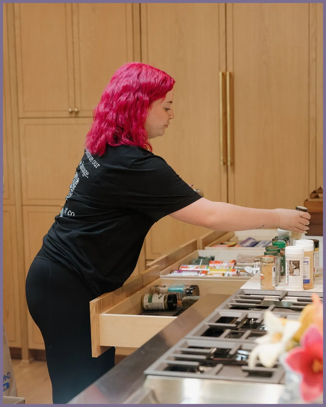 Organized spice rack with labeled glass jars and tiered pantry storage for easy kitchen organization
