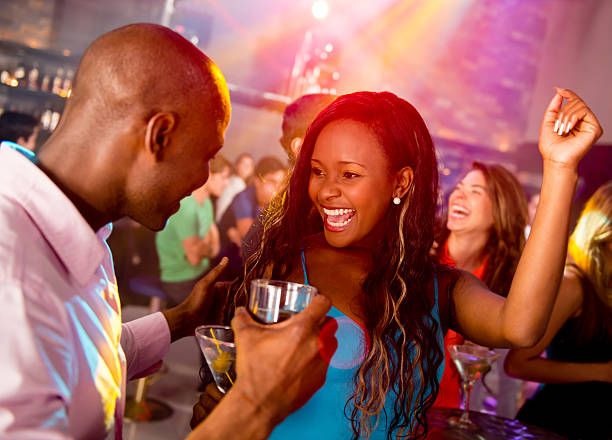 Two women dancing together in a dimly lit venue.