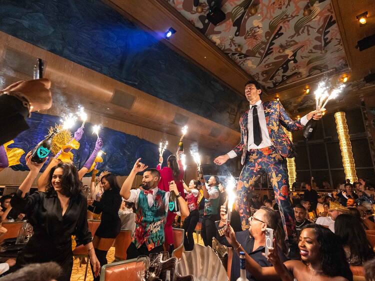 Two women dancing together in a dimly lit venue.