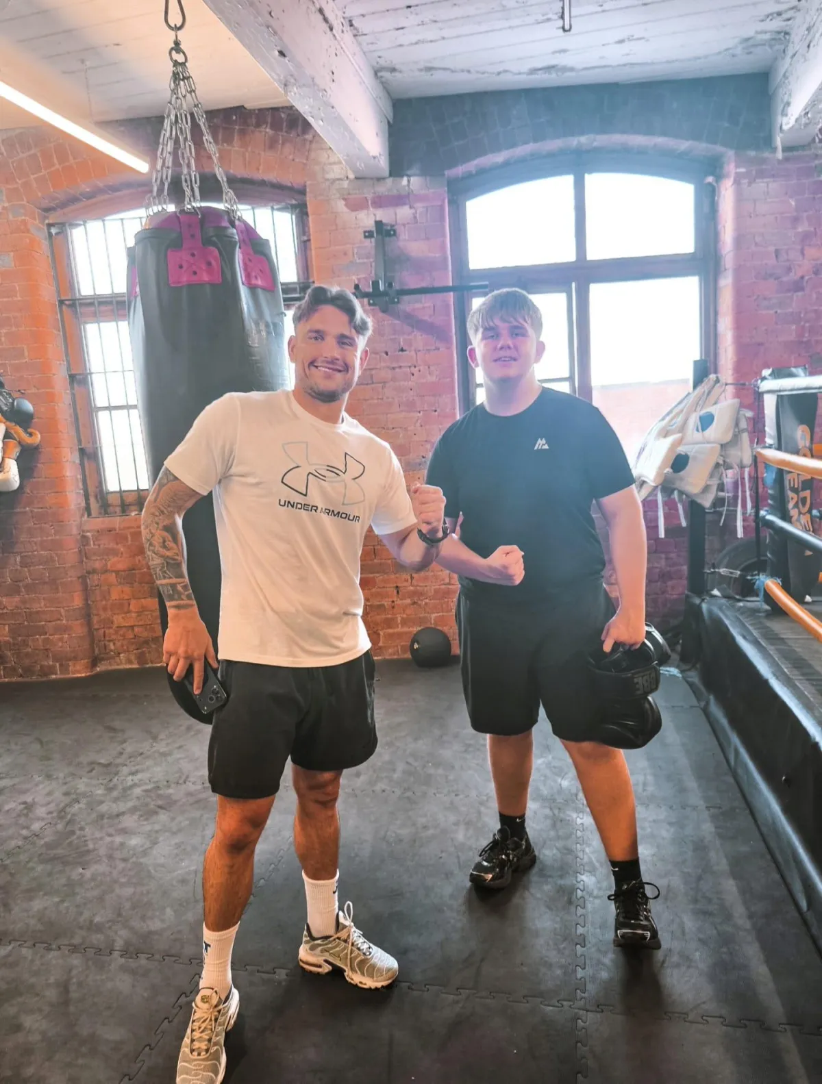 man red and black top running on farm road