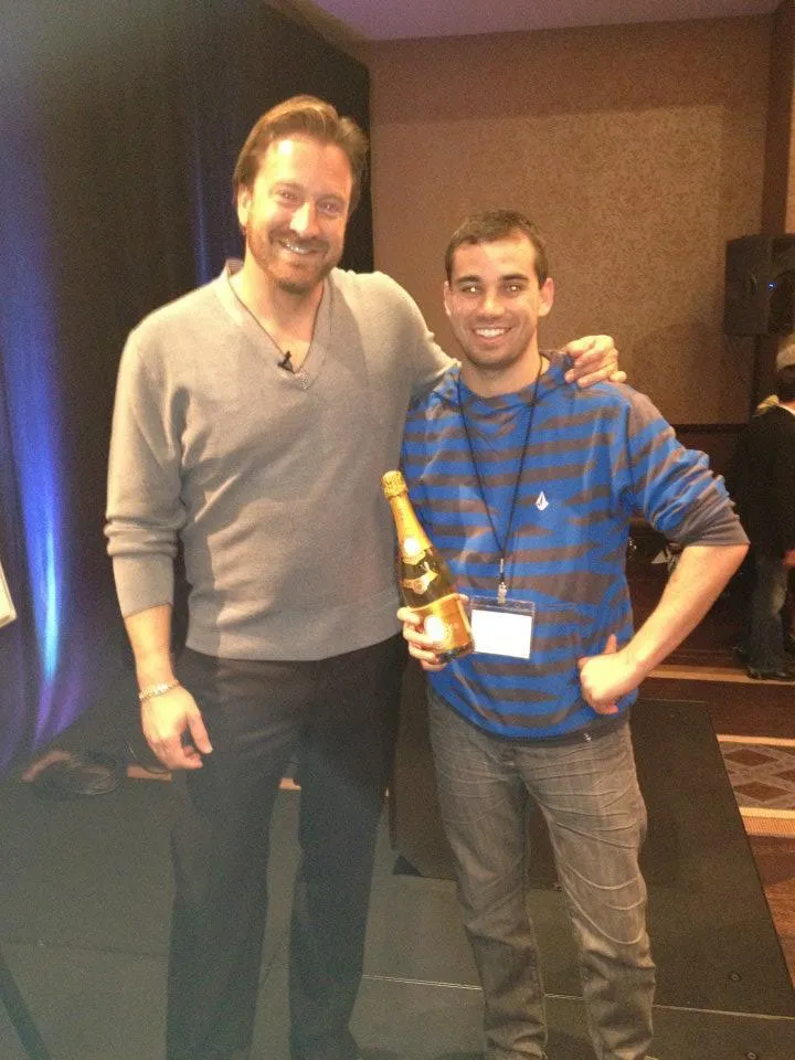 Tristan Bull with mentor Frank Kern at a marketing seminar, celebrating success in digital marketing education.