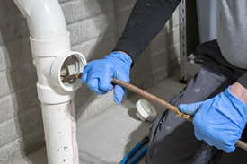 Technician using professional equipment for clogged drain cleaning service in Cincinnati Ohio home by the Drain Smith.