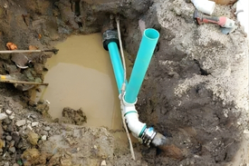 Repairing broken sewer line through excavation at Cincinnati Ohio property by the Drain Smith.