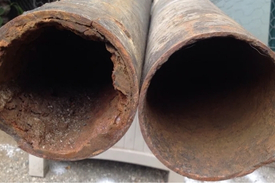 Descaling before and after removing heavy buildup inside cast iron sewer pipe in Cincinnati Ohio by the Drain Smith.