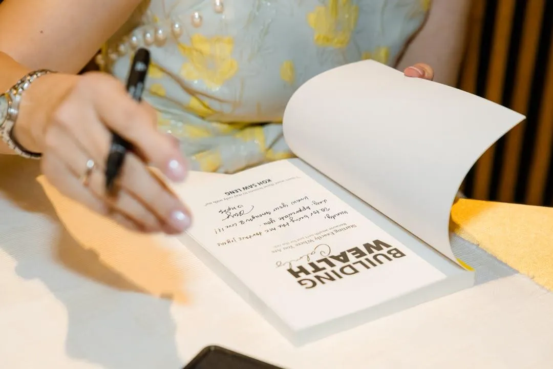 Author signing copies of Building Wealth Calmly