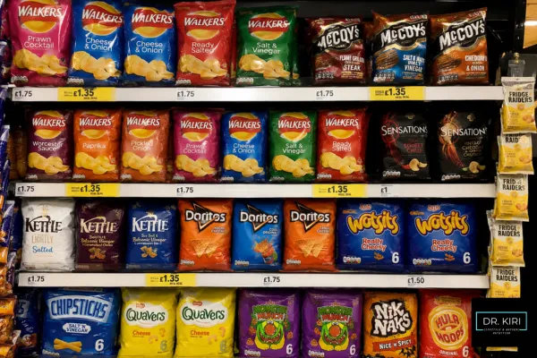 UK supermarket crisps aisle filled with colourful packets of popular snacks including Walkers, McCoy’s, Doritos and Wotsits, neatly displayed on shelves.