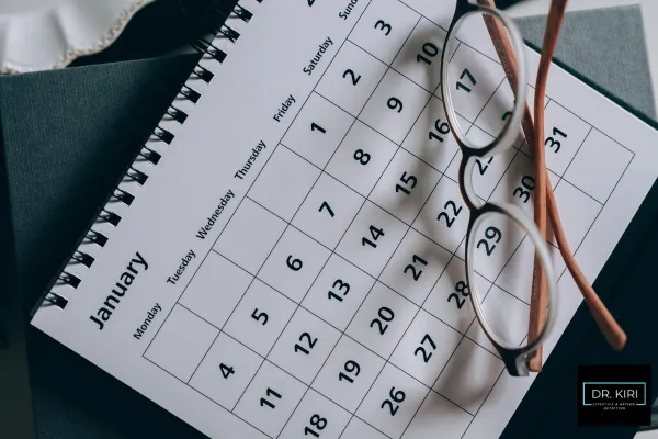 calendar with eyeglasses on a table, emphasizing planning and organization.