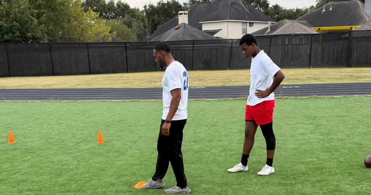 Coach giving focused one on one technique and kettlebell instruction to dedicated athlete