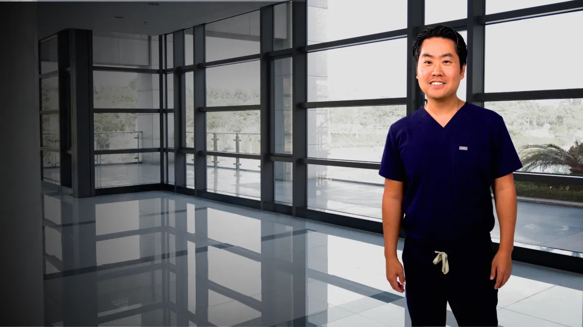 Dr. Daniel Shin in surgical scrubs