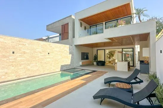 a living room with white furniture and wood floors