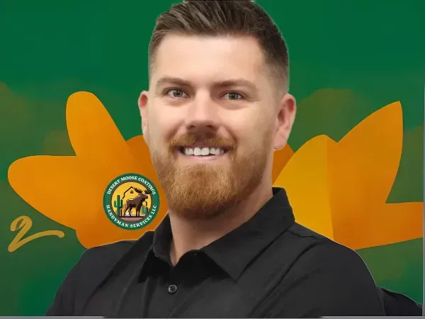 Owner of Desert Moose Coatings smiling in front of company logo background