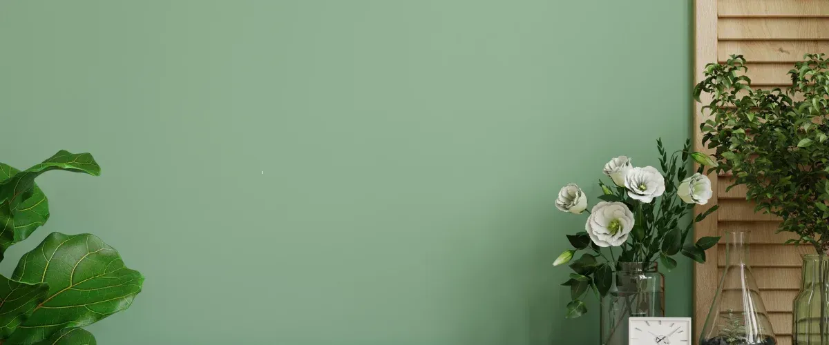 Stylish interior with green accent wall and white flowers in modern home decor