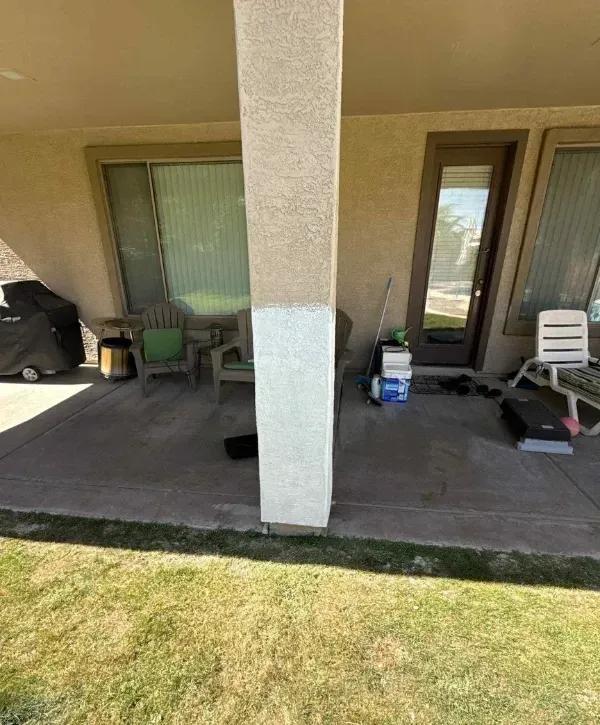 Exterior home painting preparation showing partial paint coverage on patio pillar.