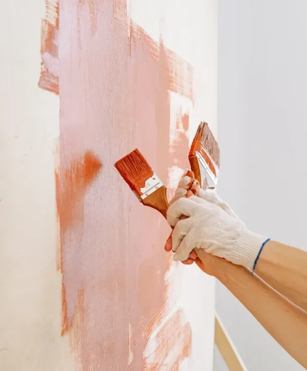 Custom wooden and metal trash bin enclosure installed beside home exterior wall 
