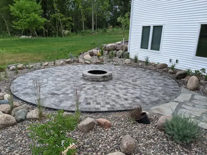 Backyard stone fire pit installation in Minnesota