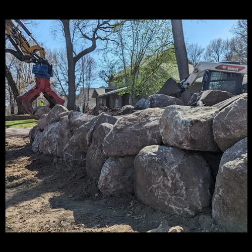 Stone retaining wall with boulders