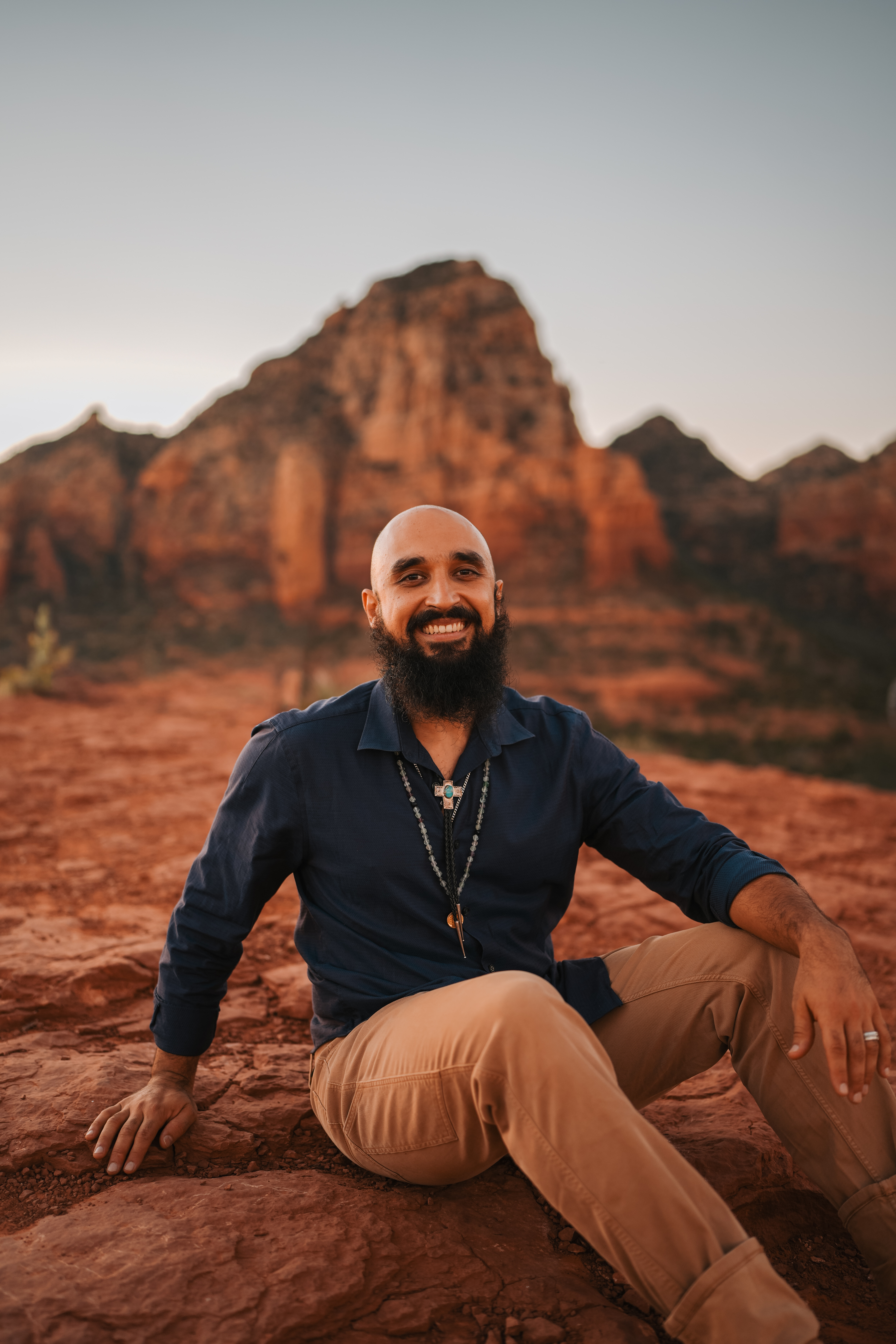 Professional shot of Michael with hand over heart, looking at the landscape.
