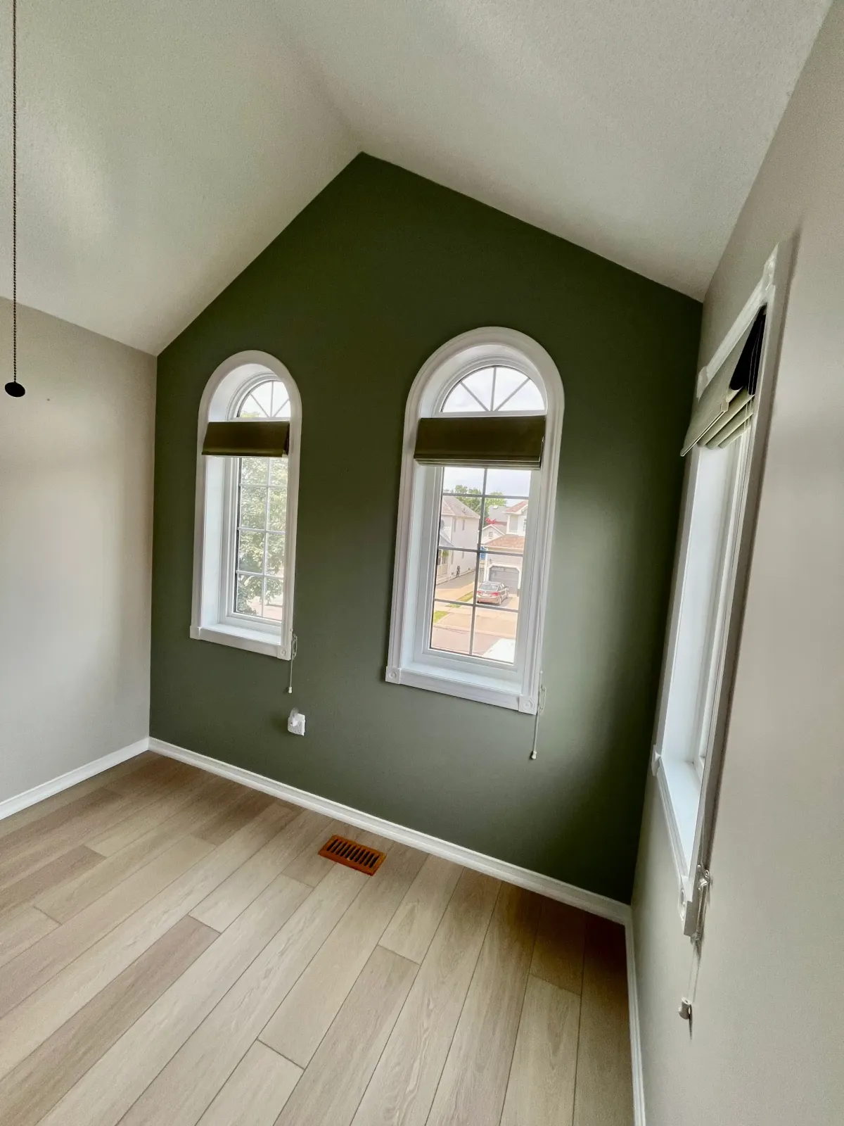 Olive green accent wall with white trim in a vaulted nook — painting project in The Beaches, Toronto