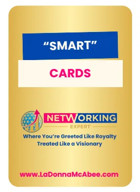 A 1:1 image of a hand fanning out several Smart Cards on a wooden desk. The cards display different prompts in bold, colorful fonts. Sunlight streams in from a window, highlighting the textures of the cards and the natural wood surface. No people are visible beyond the hand.