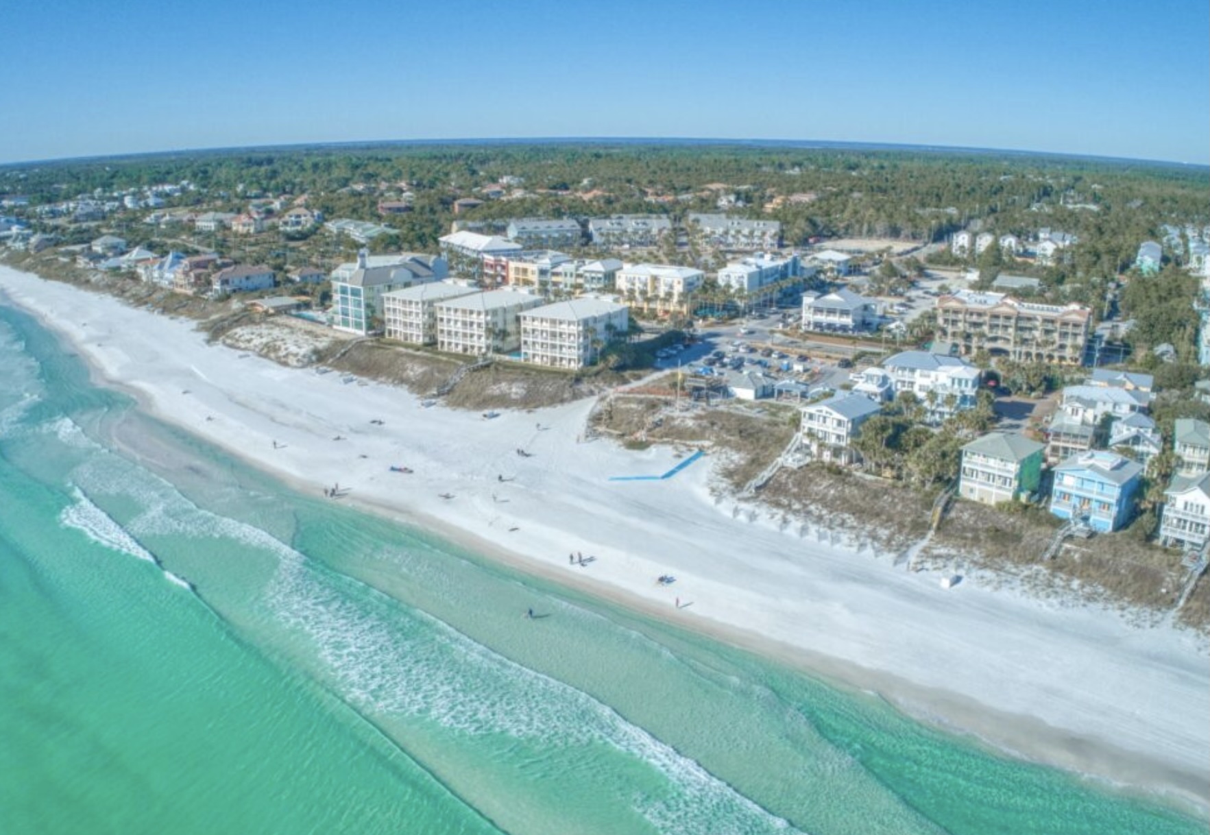Aerial view of Santa Rosa Beach, Florida showing white sand beaches, emerald Gulf waters, and coastal homes along Scenic Highway 30A.