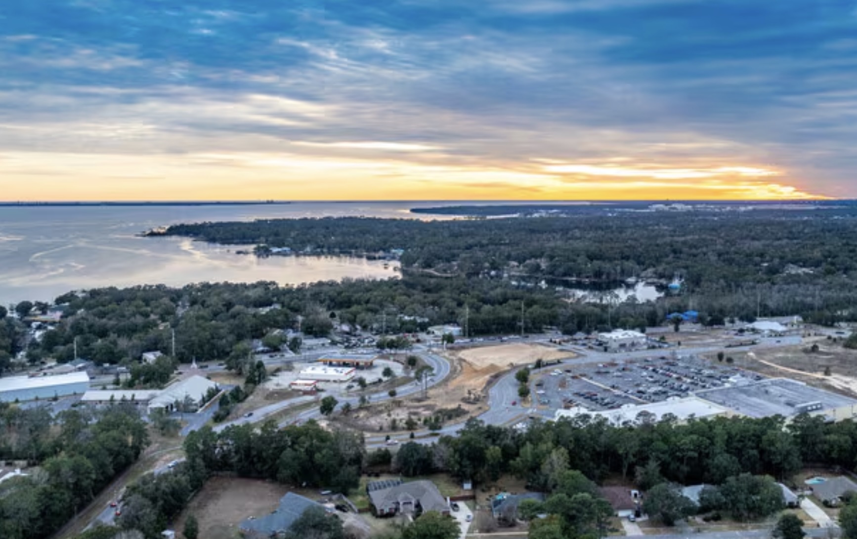 Aerial view of Niceville, Florida overlooking Choctawhatchee Bay and surrounding neighborhoods at sunset