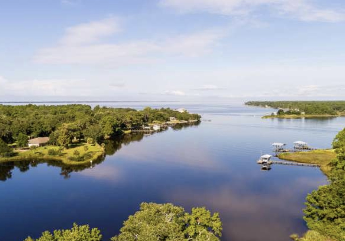 Aerial view of Freeport, FL with waterfront homes and scenic bay views.