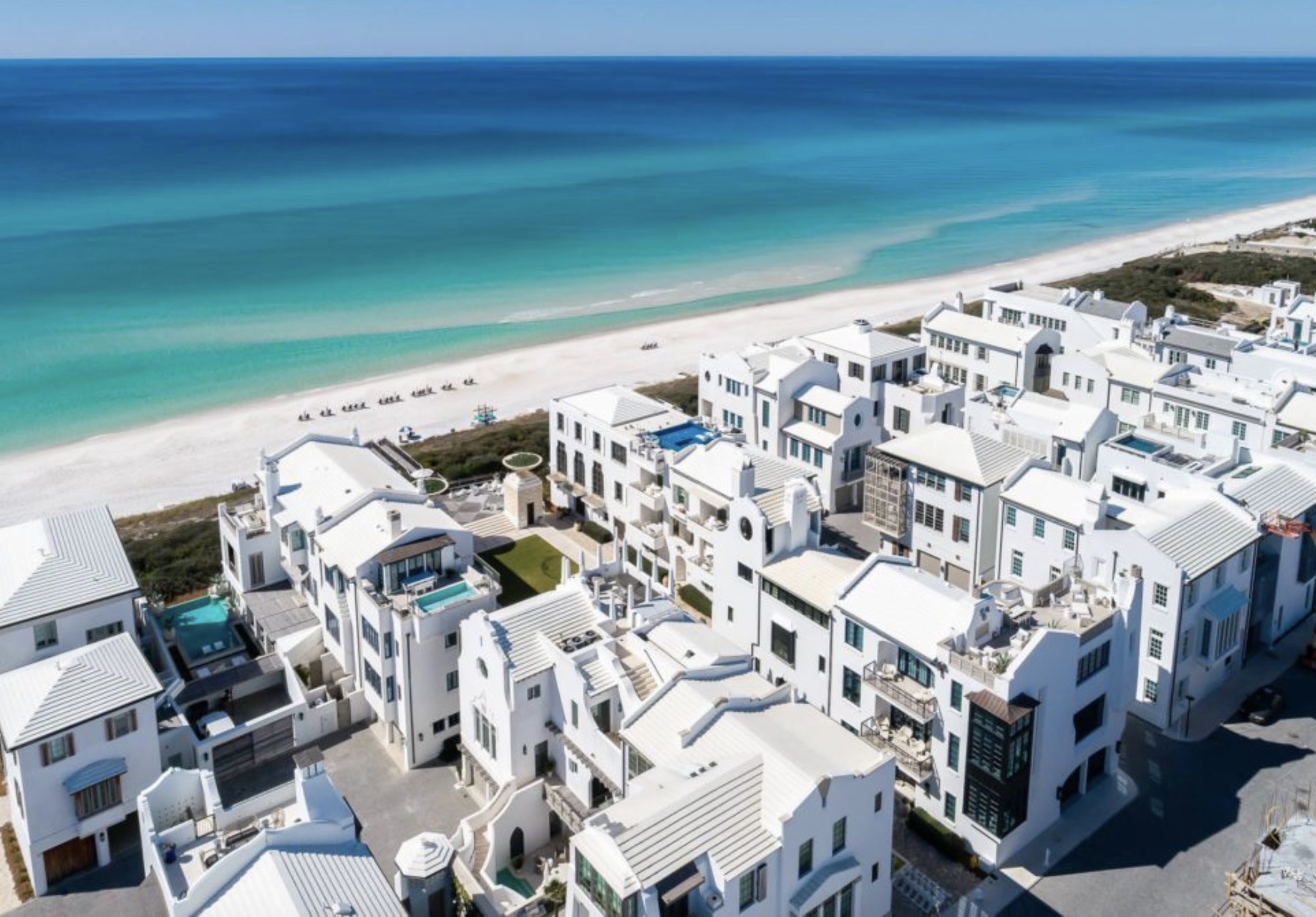 Aerial view of Alys Beach, Florida featuring white coastal homes along the Gulf of Mexico and turquoise waters.