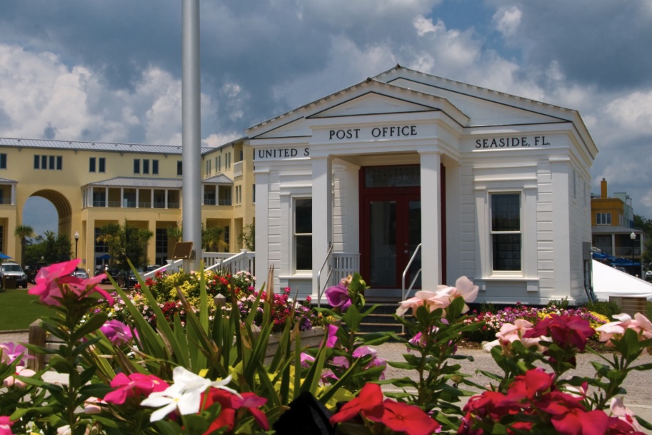 Historic Seaside, Florida post office surrounded by colorful flowers in the town square along Scenic Highway 30A