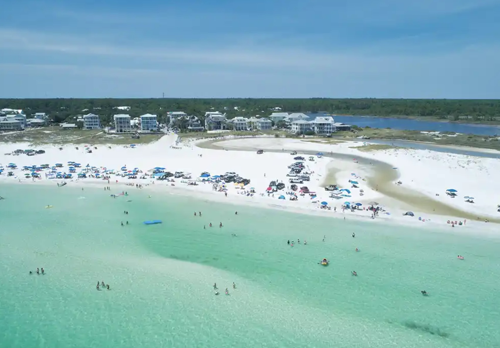 Aerial view of Grayton Beach, Florida featuring white sand beaches, emerald green Gulf waters, and beachfront homes along the shoreline.