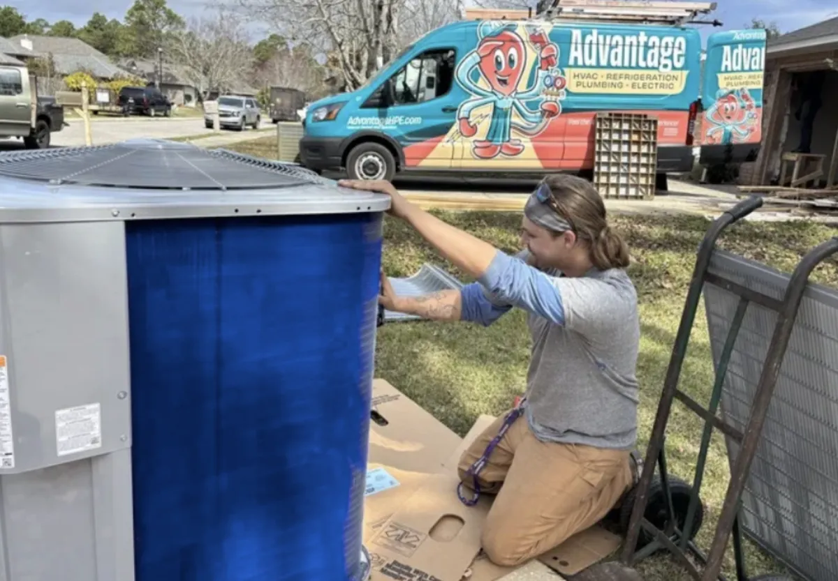 Advantage HVAC, Plumbing, and Electrical technician performing maintenance on an hvac system