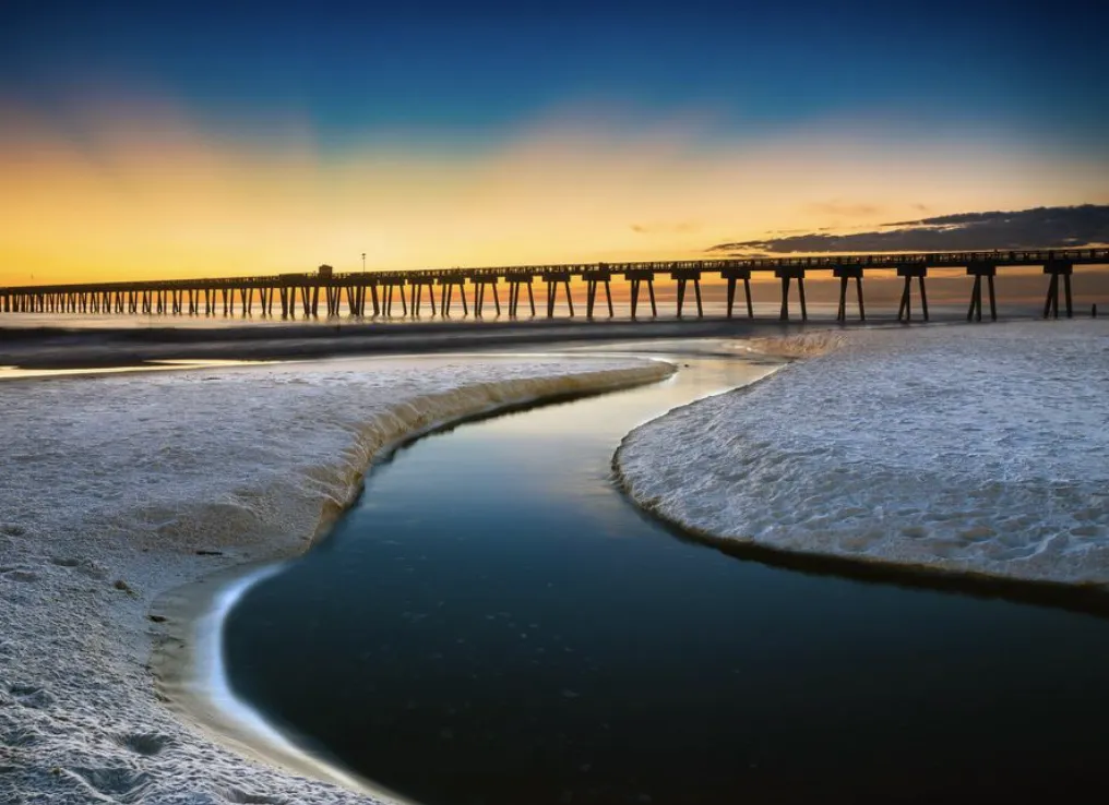 Sunset view of the Gulf Coast shoreline and pier near Callaway, Florida