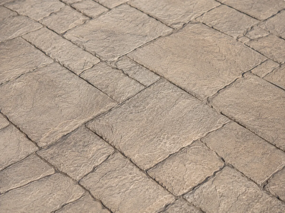 Stamped concrete driveway with decorative pattern and textured finish.