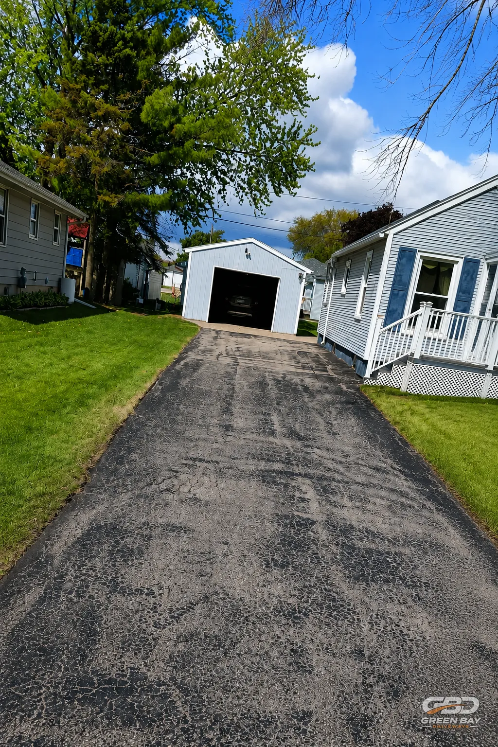 Cracked driveway surface before repair and restoration work begins