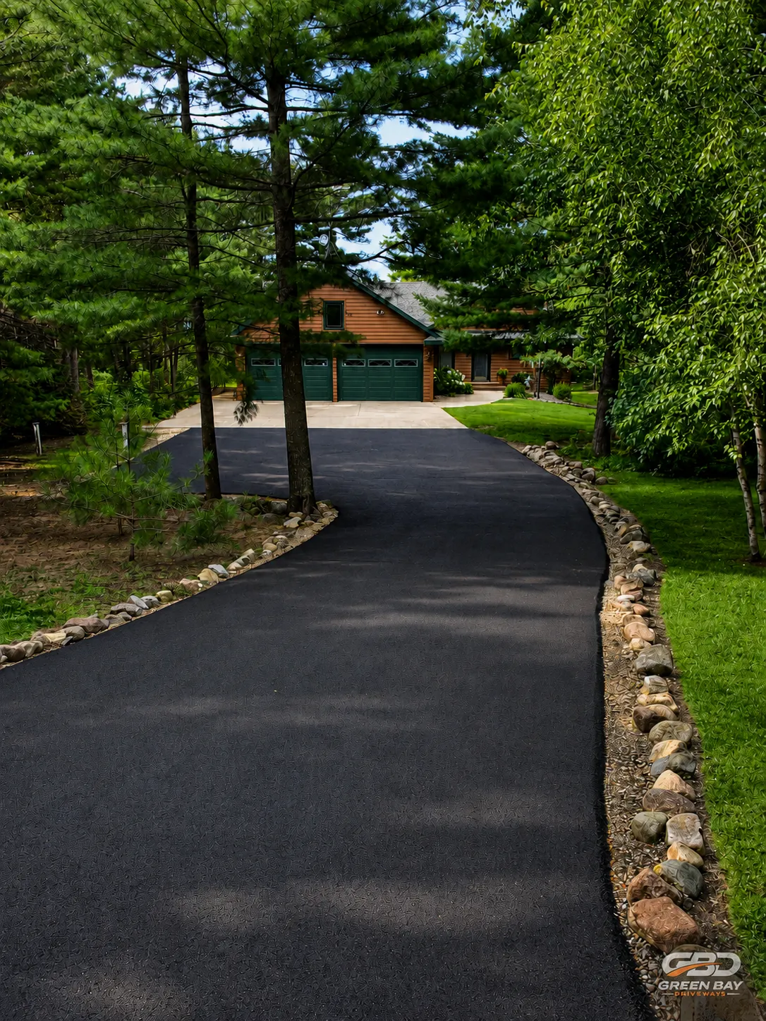 Long freshly paved asphalt driveway showing smooth, continuous finish