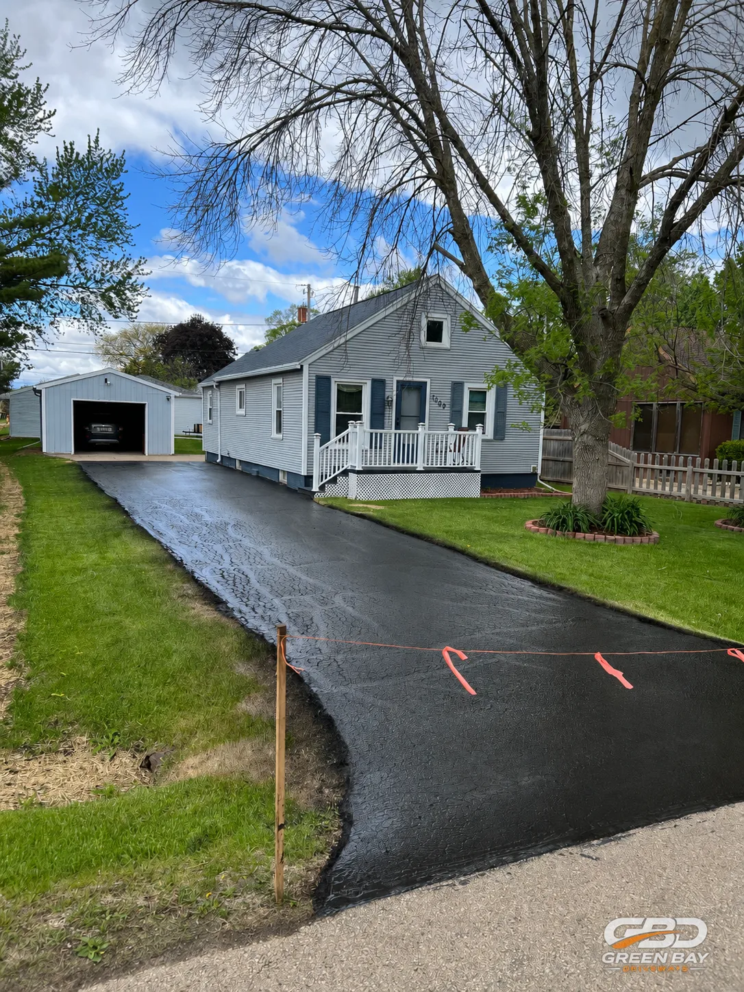 Completed driveway repair with sealed, smooth, and restored surface