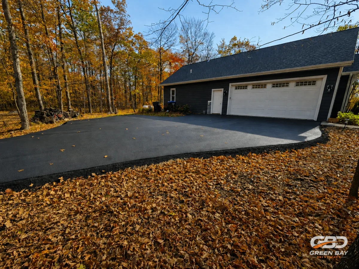 Newly paved asphalt driveway with smooth, even blacktop finish
