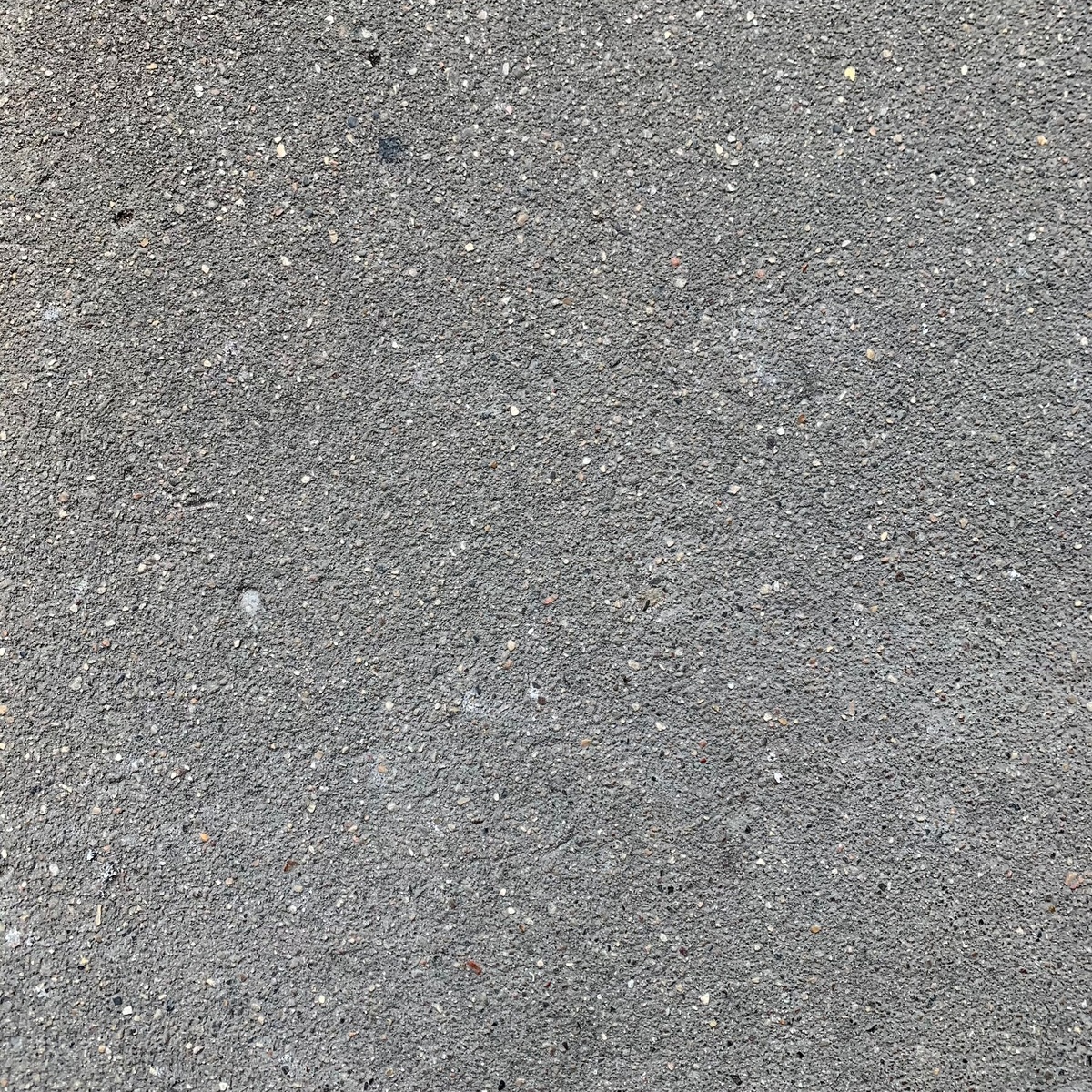 Close-up view of smooth concrete driveway surface texture