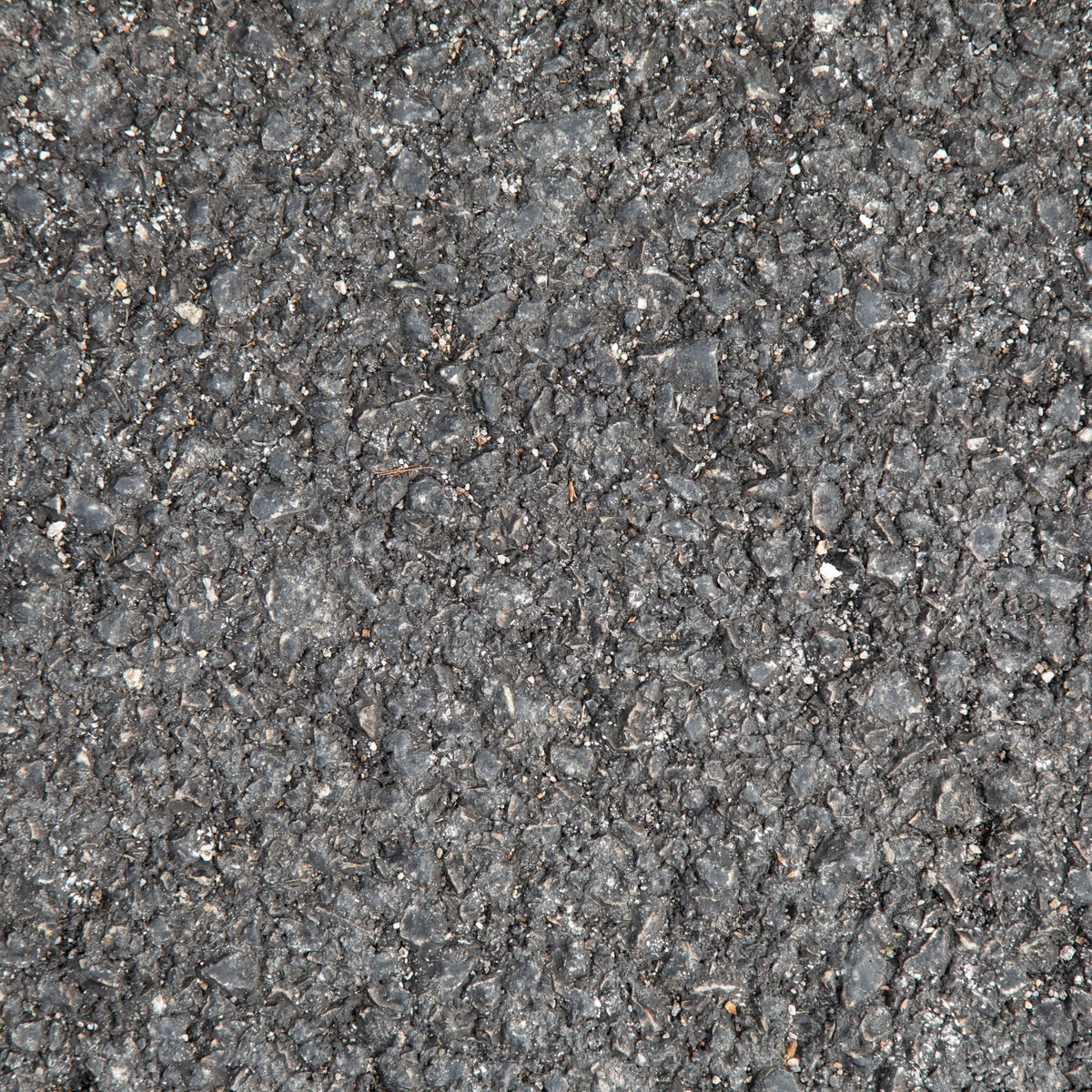 Close-up view of asphalt driveway surface texture