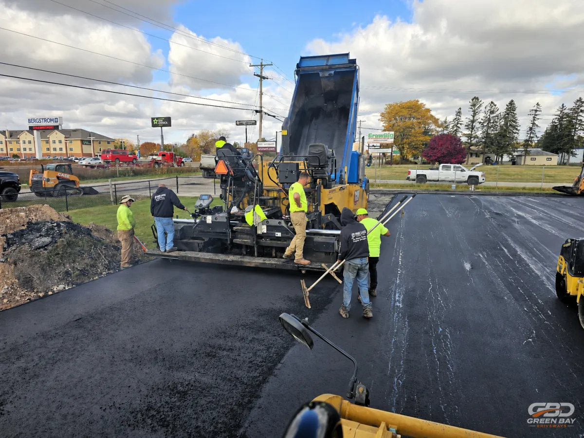Green Bay Driveways construction crew members smiling on a local Green Bay job site