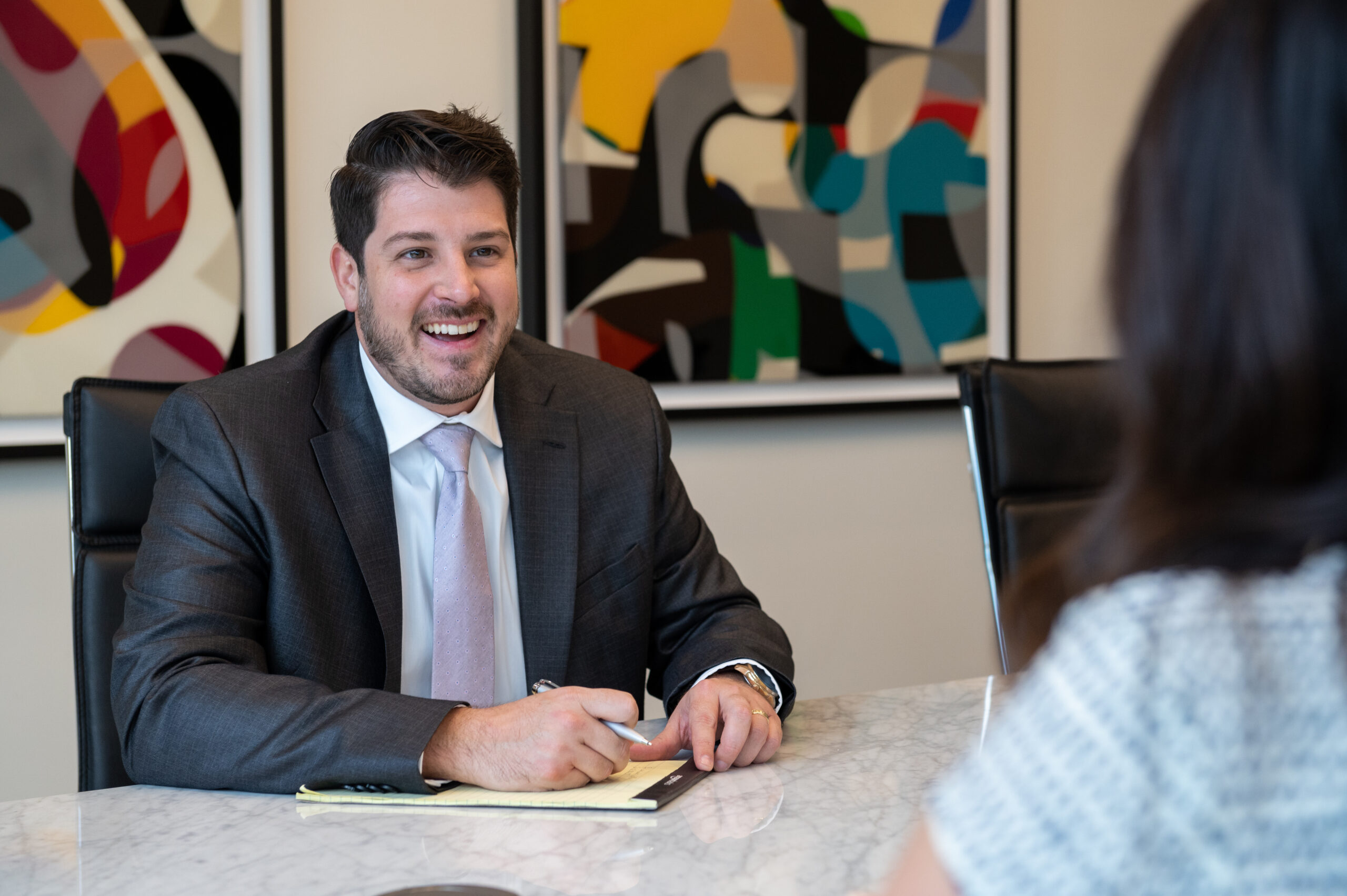 Smiling client and legal professional reviewing documents together