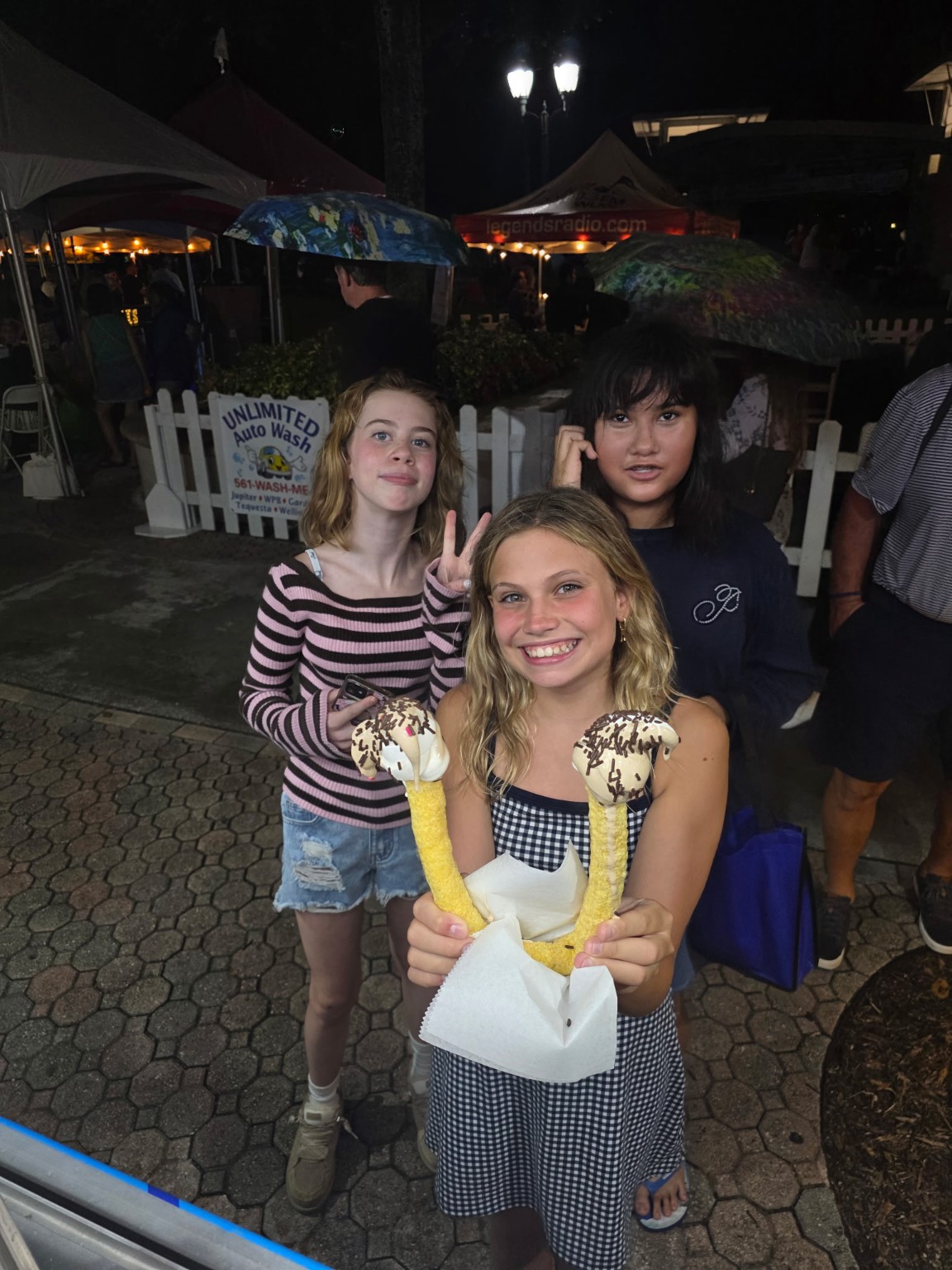 Young guests with a signature U-Cone topped with soft serve and chocolate sprinkles at an evening event