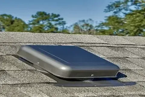 Dome-style attic ventilation unit installed on residential asphalt shingle roof