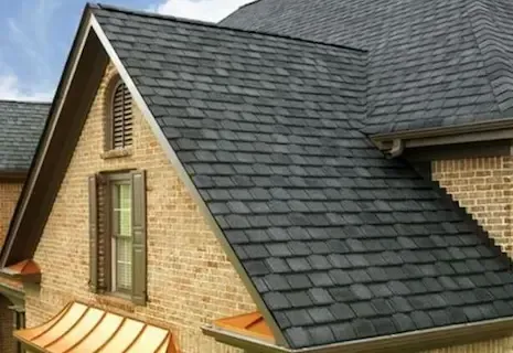 Brick home with freshly installed dark slate-style shingles and clean roofline
